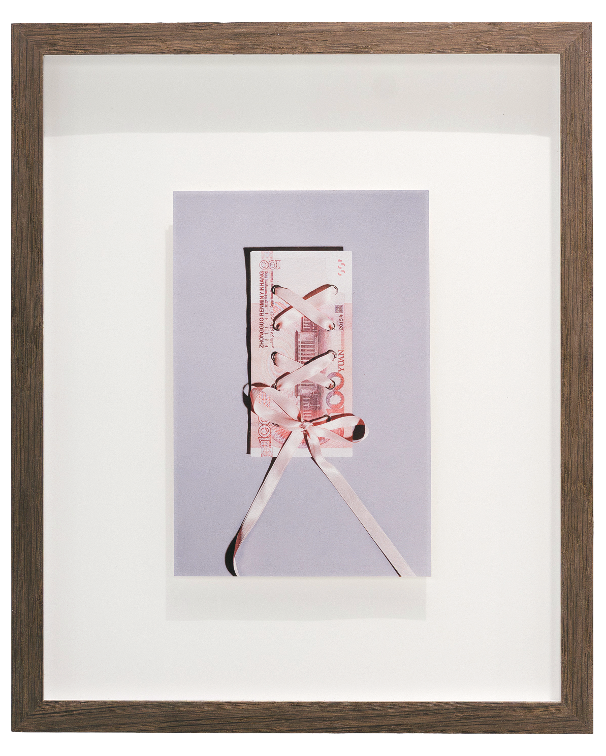 Fine art photograph by Alaïa Fonk of a 100 yuan banknote laced with a ribbon, presented as a framed artwork.